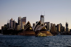 View of Sydney Opera House and skyline, taken from a harbor ferry.